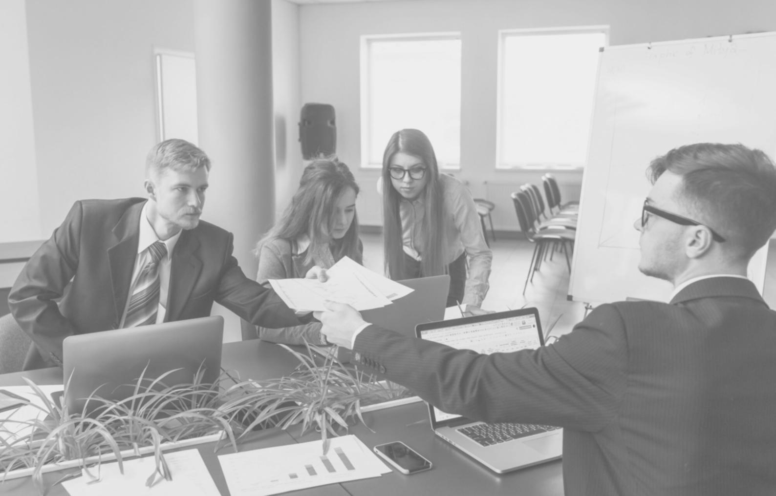 Detailed financial analysis and business planning documentation spread across desk